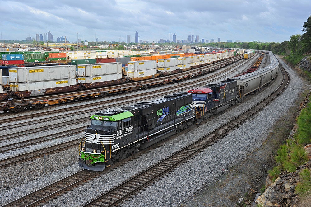 GoRail and Veterans locomotives pulling a trainload of covered hoppers into Inman Yard. 