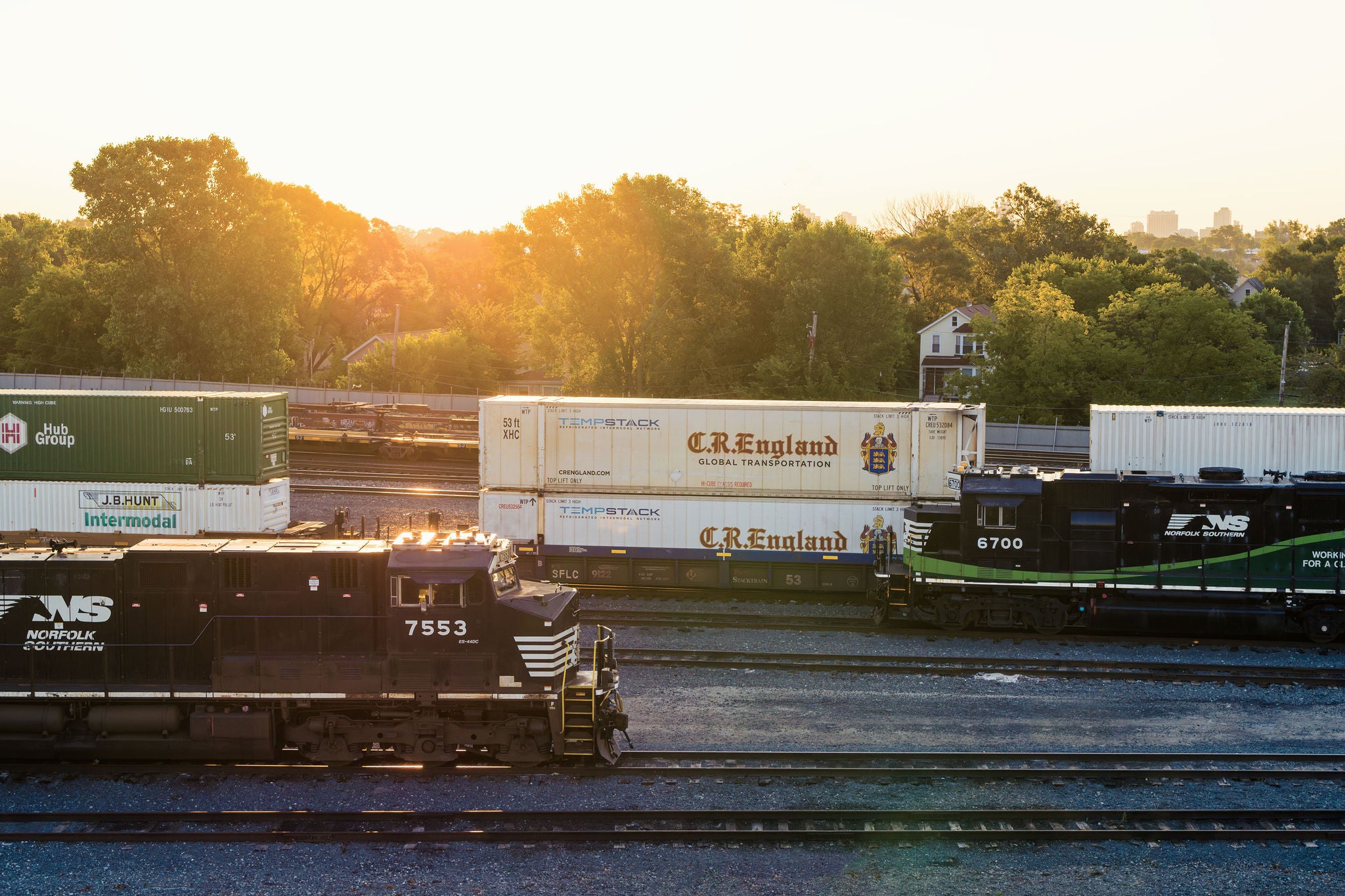 Two Norfolk Southern intermodal shipping trains heading in opposite directions on the company’s railway tracks
